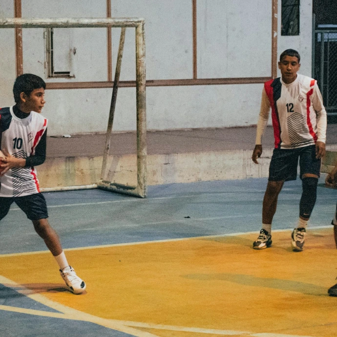 A group of young men playing a game of basketball